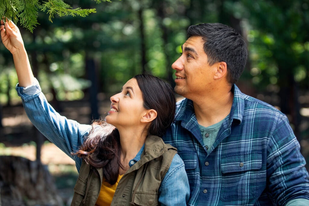Sister showing her brother the branch of a Memorial Tree