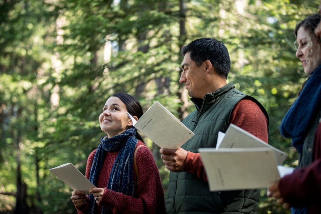 Young woman sharing a reading at a Forest Memorial ceremony