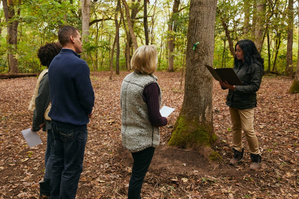 Family gathers in a Memorial Forest for a Forest Memorial ceremony led by a Guide