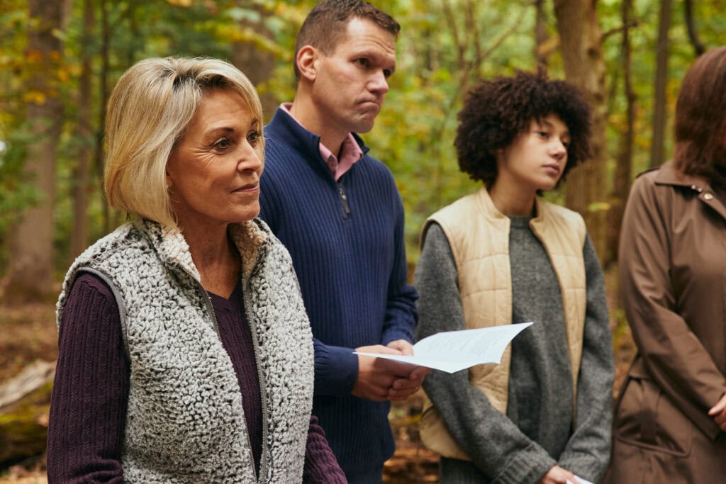Family at a Forest Memorial ceremony sharing readings