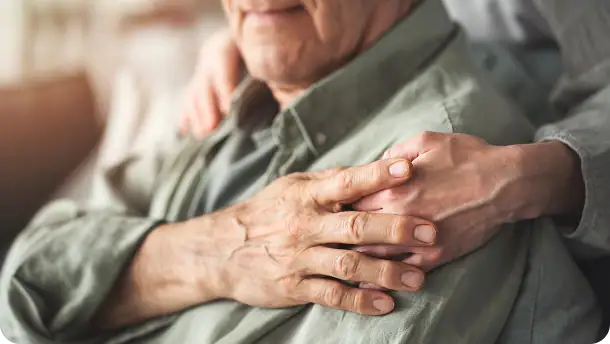 Comforting hand on shoulder supporting elderly man