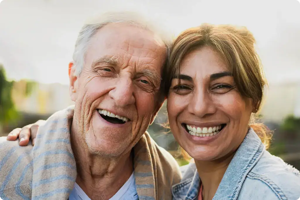 Happy friends with diverse age and ethnicity having fun smiling in front of a camera