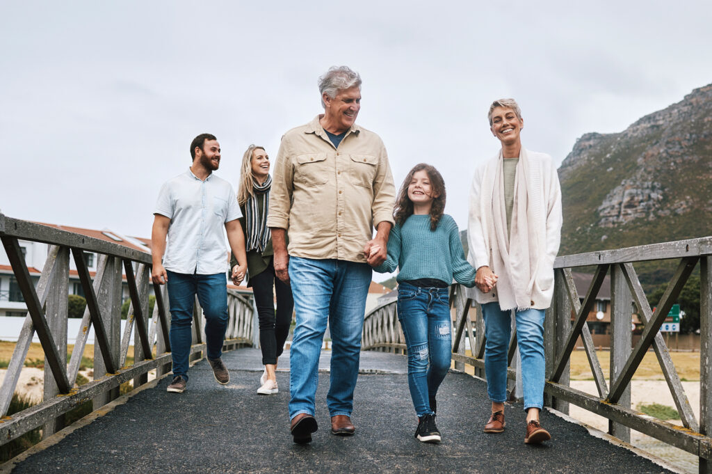 Grandparents, children and grandchildren taking a walk together outdoors