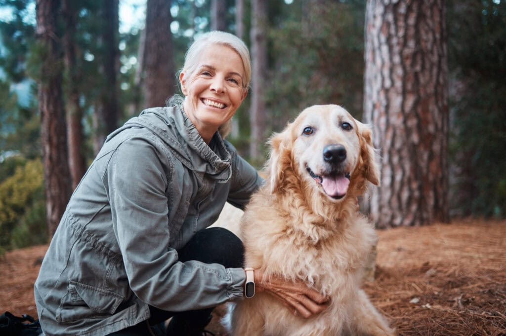 Woman hugging her beloved pet dog in a memorial forest