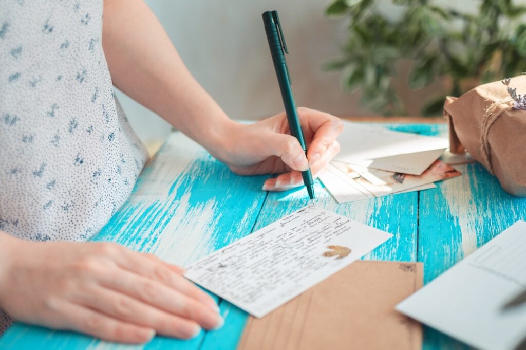 Woman writes a sympathy card
