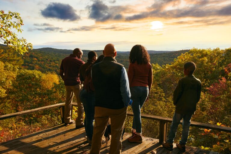 a group of mourners stands still in a moment of silence