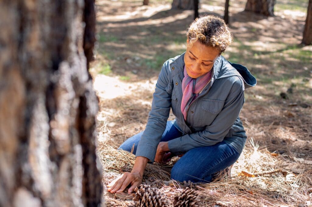 A woman places her hand on a memorial marker