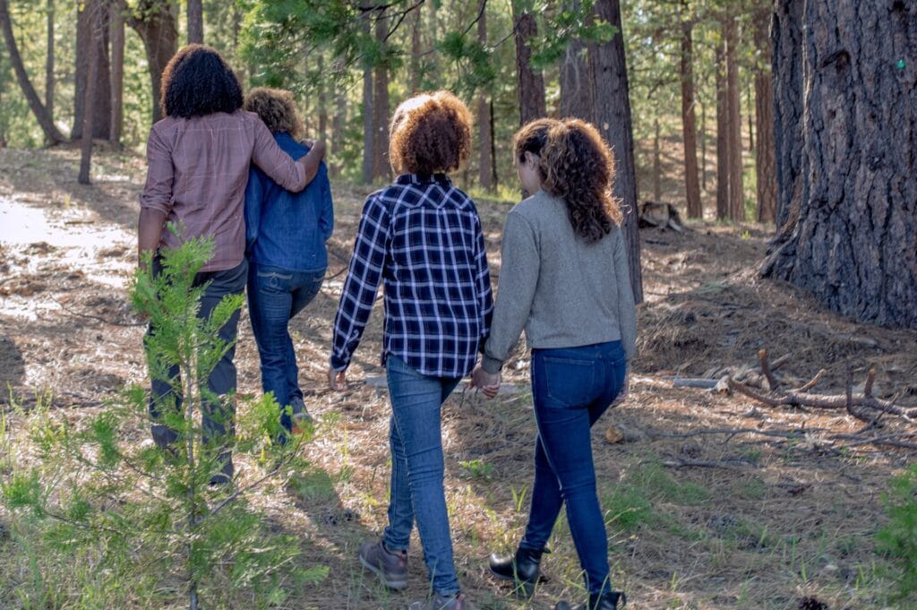 A family with teenagers walks through a memorial forest