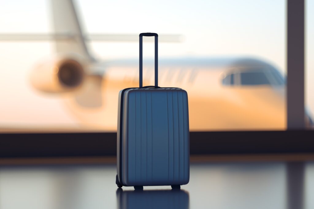 a carry on bag with plane in background