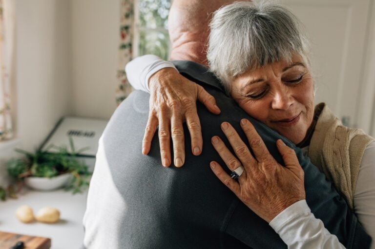 man embraces woman in support