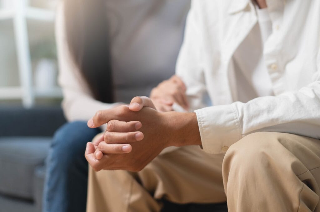 hands clasping in grief support