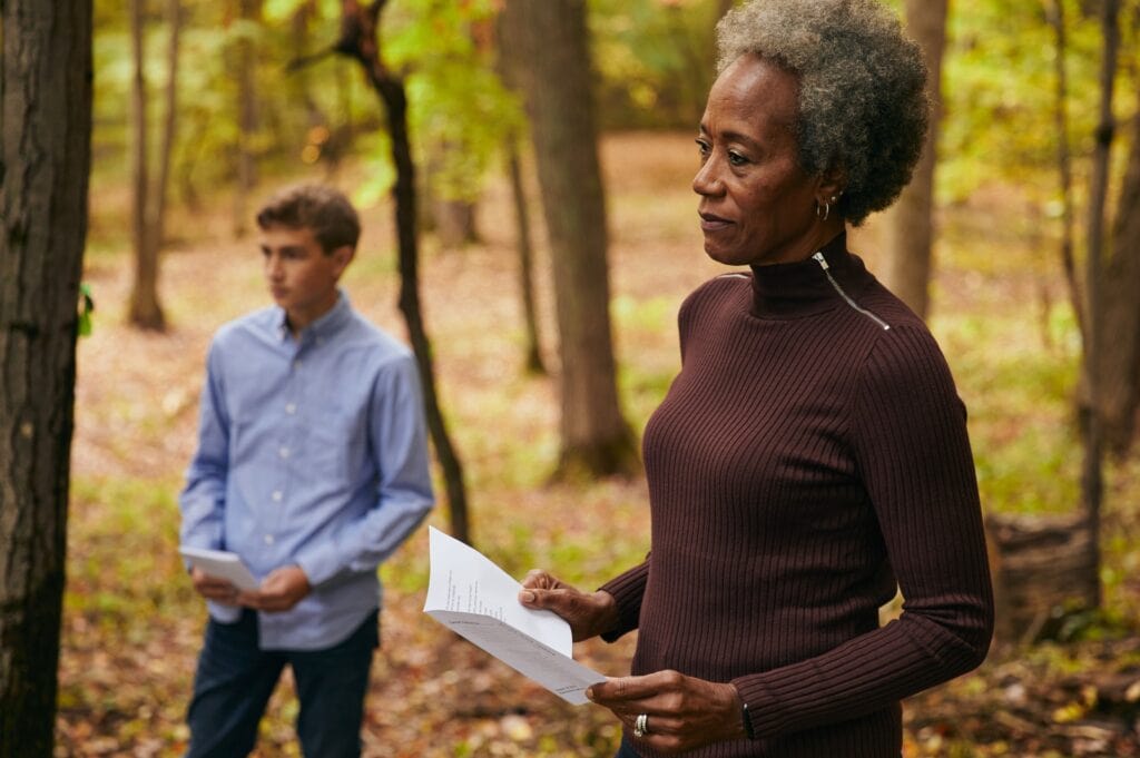 A woman reads a eulogy at a memorial service