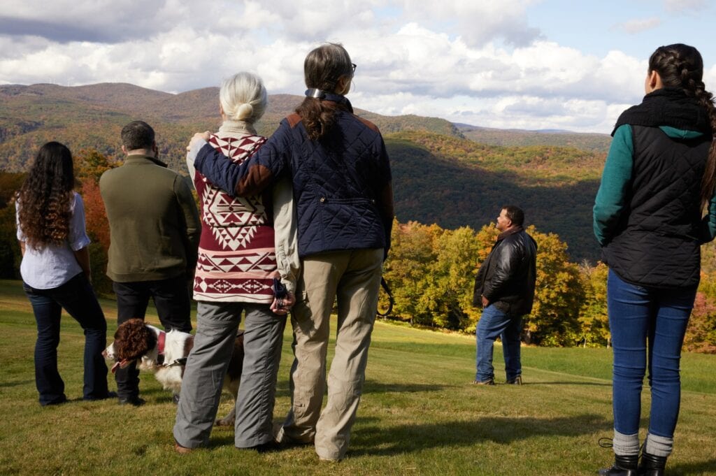 A family stands together in a memorial forest