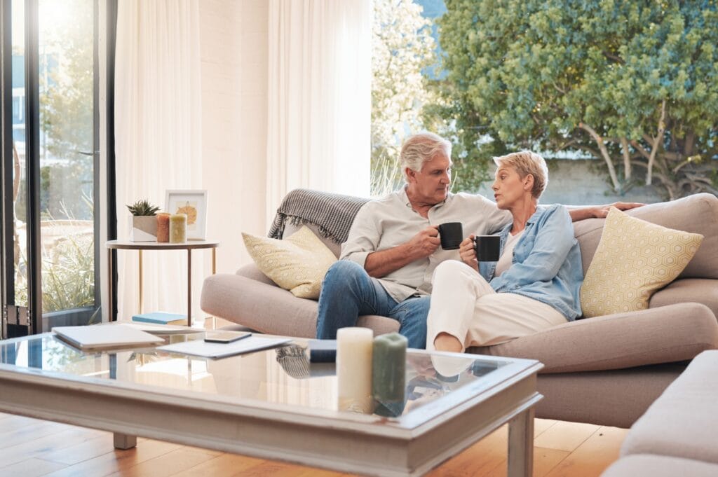 An elderly couple sits together for end of life planning