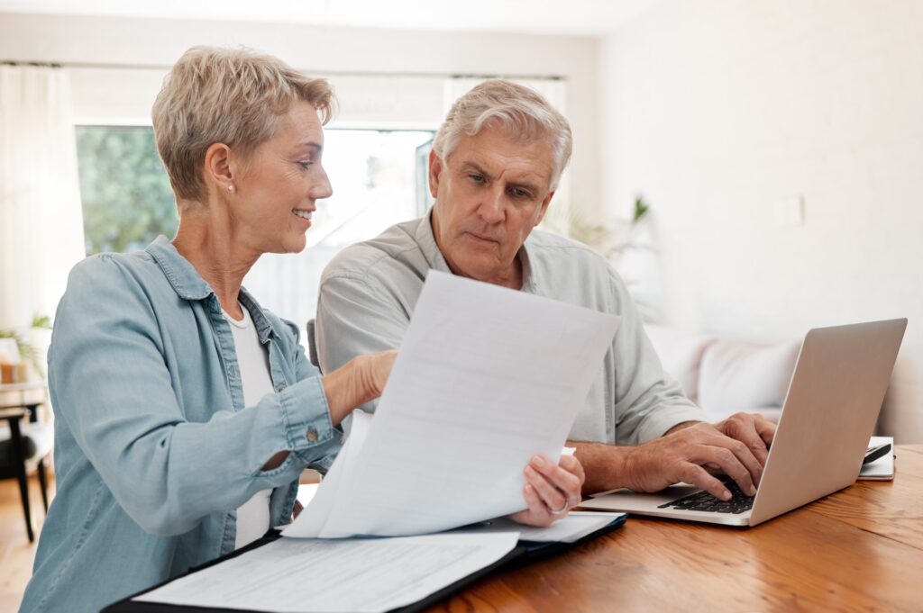 An elderly couple sits together for end of life planning