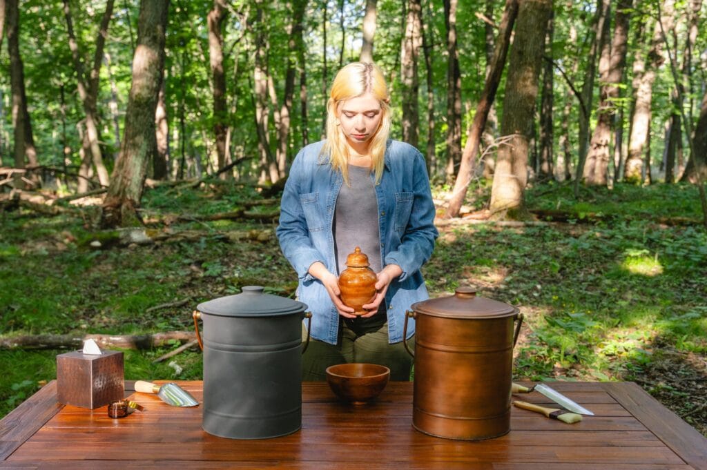 A woman holds a cremation urn in a memorial forest