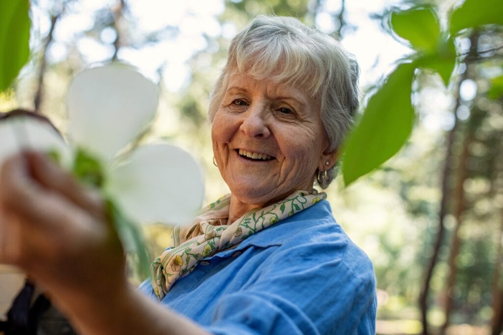 Elderly woman enjoying nature in a memorial forest