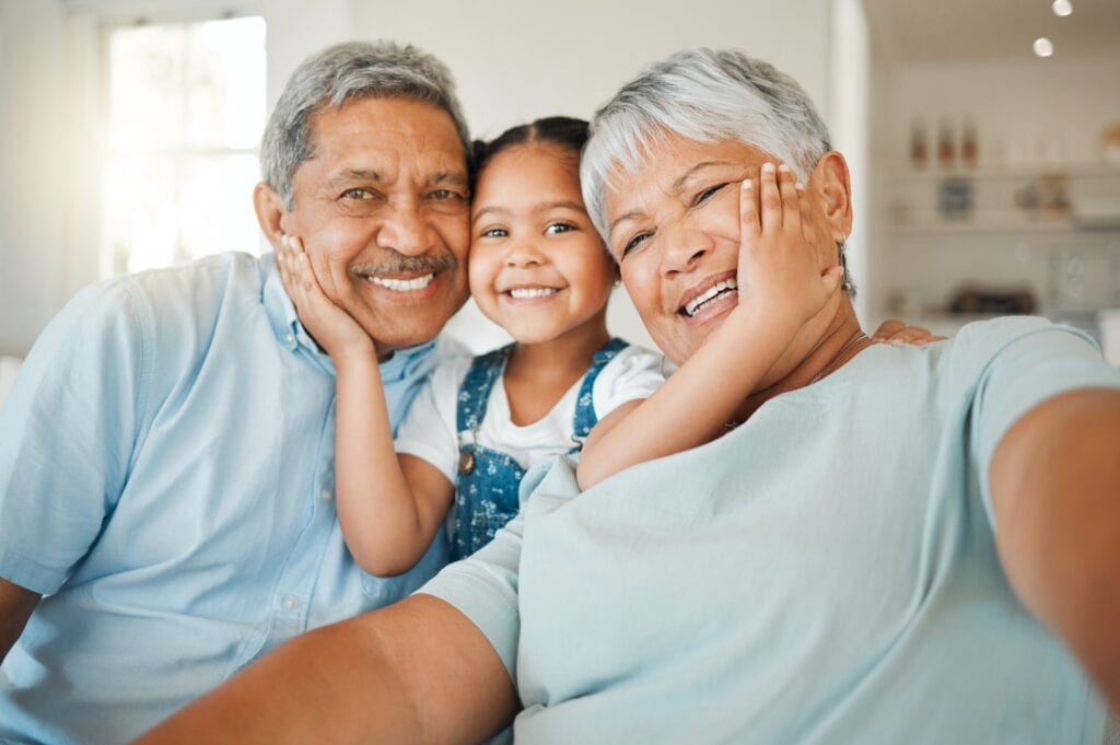 Elderly grandparents with their granddaughter
