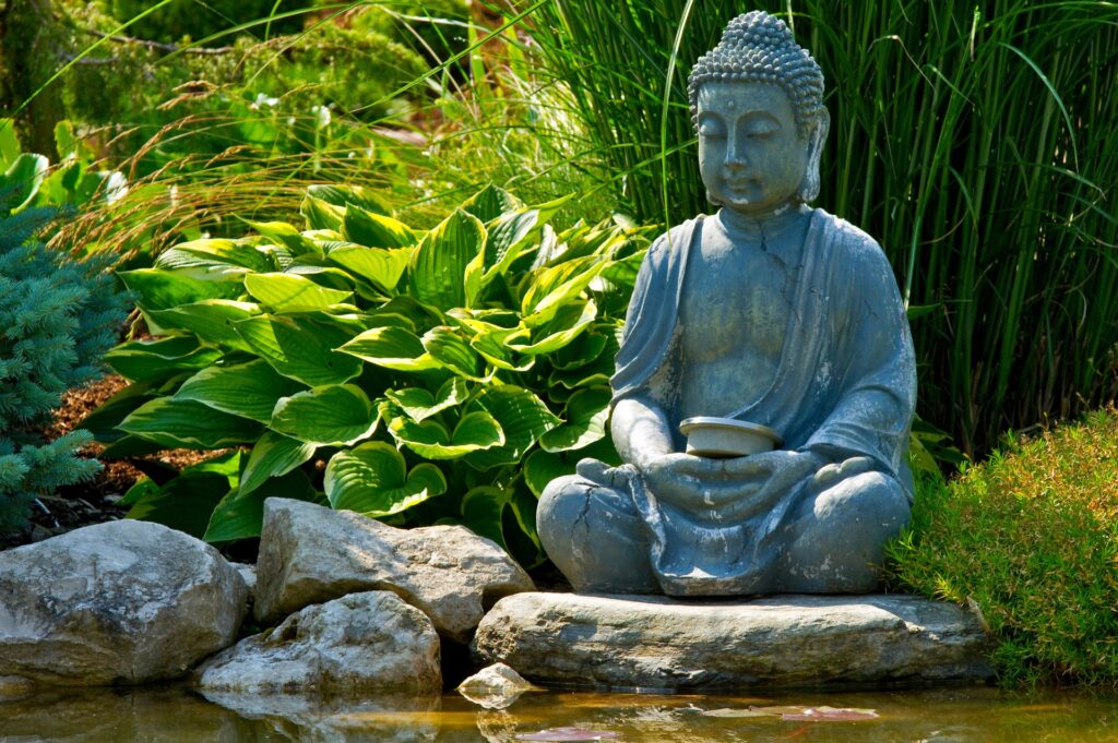 A Buddhist statue by a pond