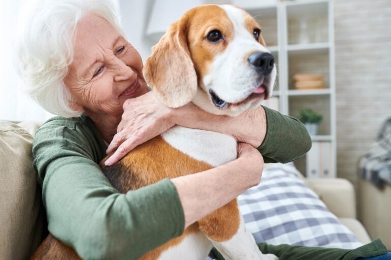An elderly woman with her elderly pet