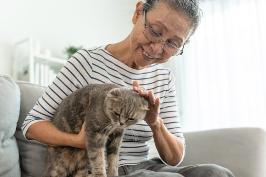 An elderly woman with her elderly pet