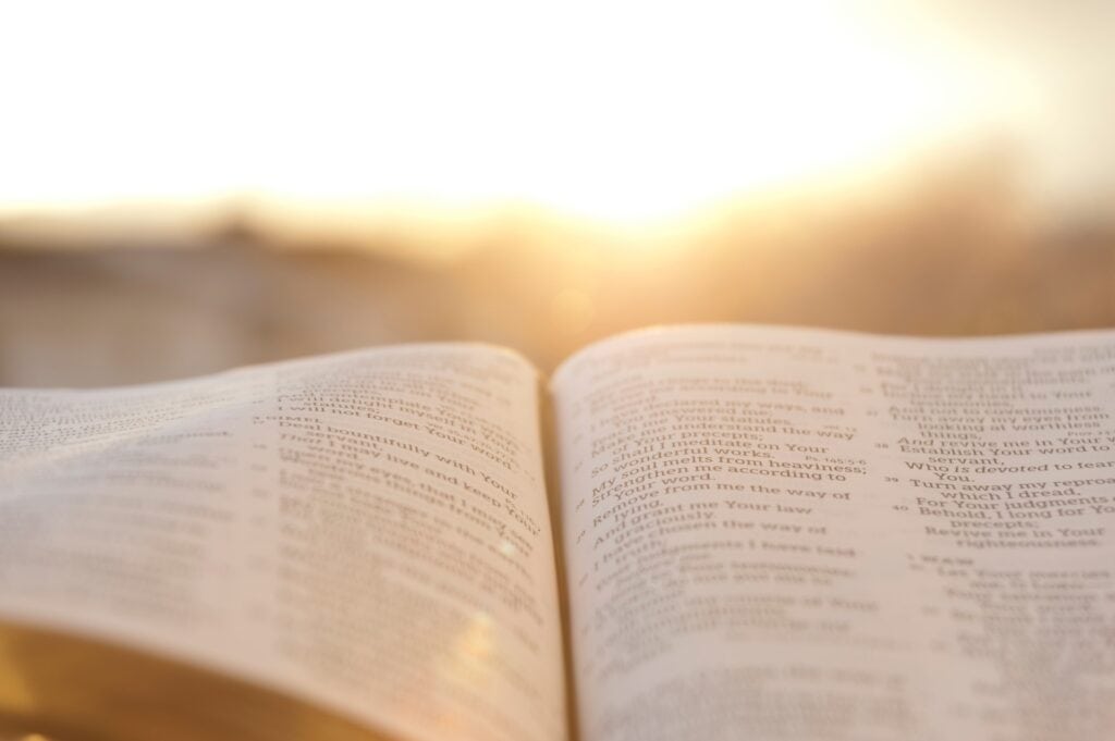 An open bible with soft light from the sunsetting