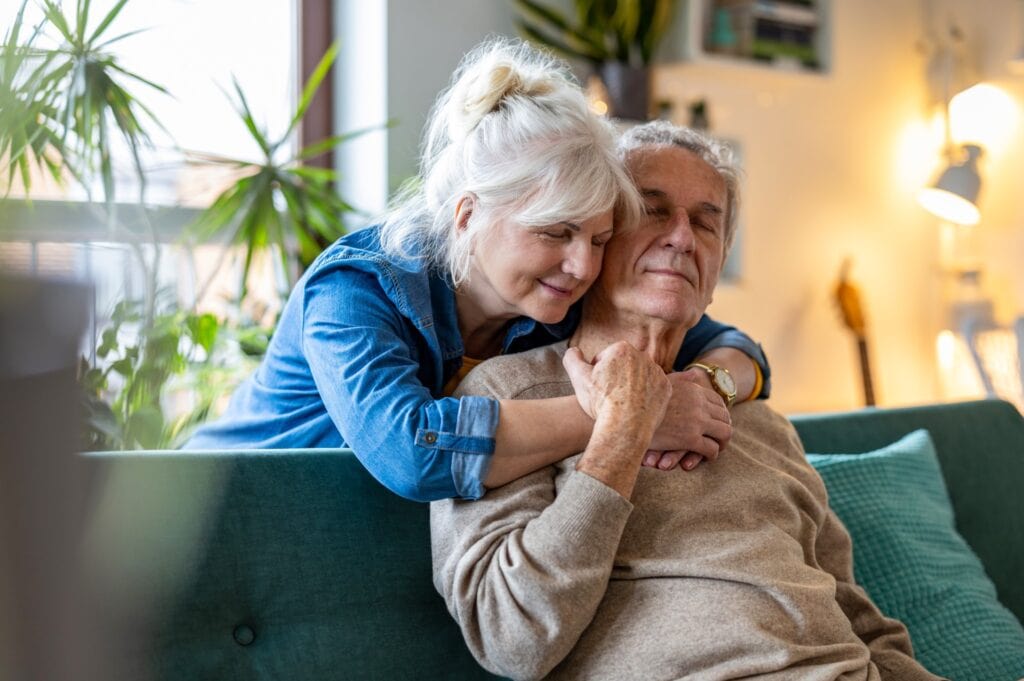 A woman comforts a senior man