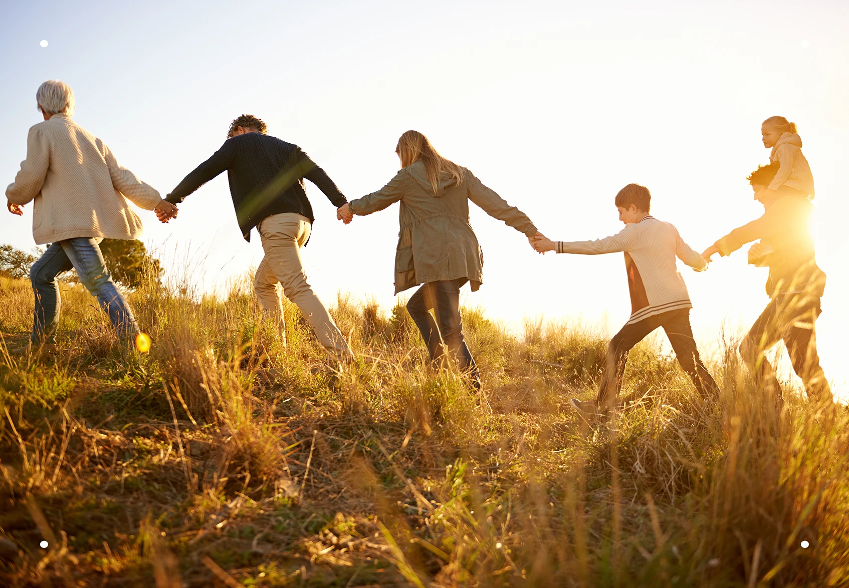 Happy family holding hands on a morning walk, symbolizing comfort, connection, and the lasting support Everis provides beyond arrangements.