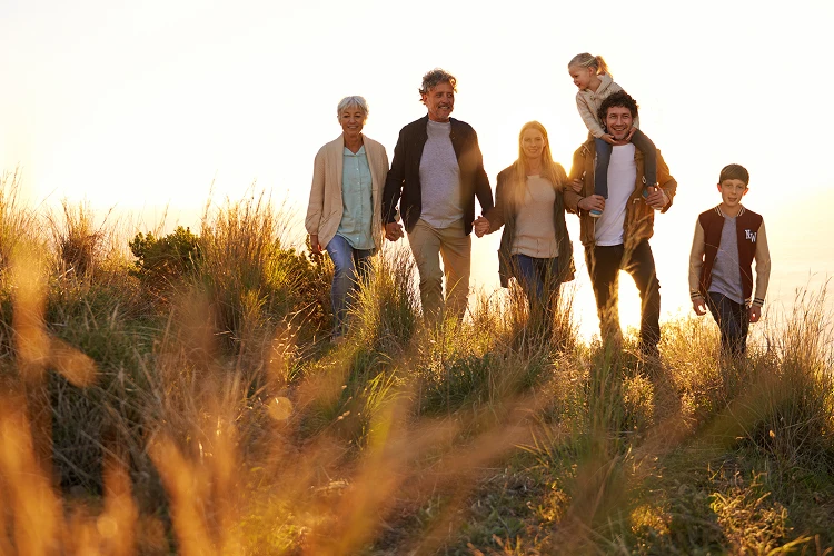 Happy family walking together on a sunny morning, symbolizing warmth, connection, and Everis’s commitment to eco-friendly, carbon-neutral cremation options.