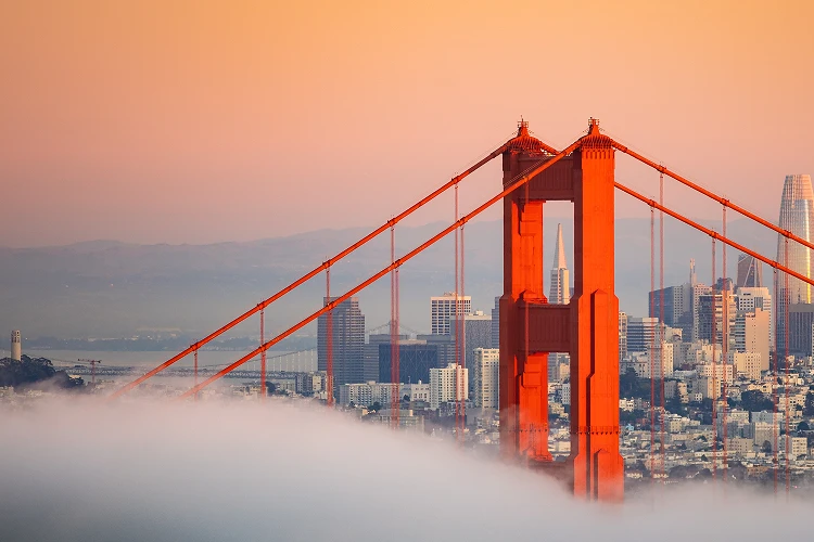 Golden Gate Bridge at sunset with the San Francisco skyline in the background, symbolizing compassionate, modern cremation care for Bay Area families.