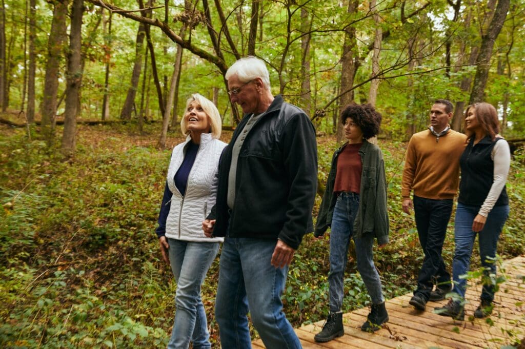 a family enjoying a walk through Rock River Memorial Forest