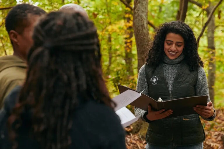 A woman leads a memorial service in a memorial forest