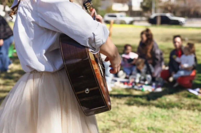 A woman plays guitar at a memorial service