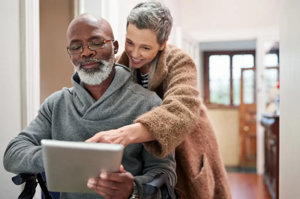 Older couple using a tablet to write an obituary