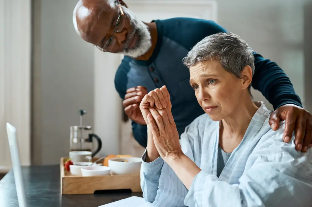 Older couple writing an online obituary