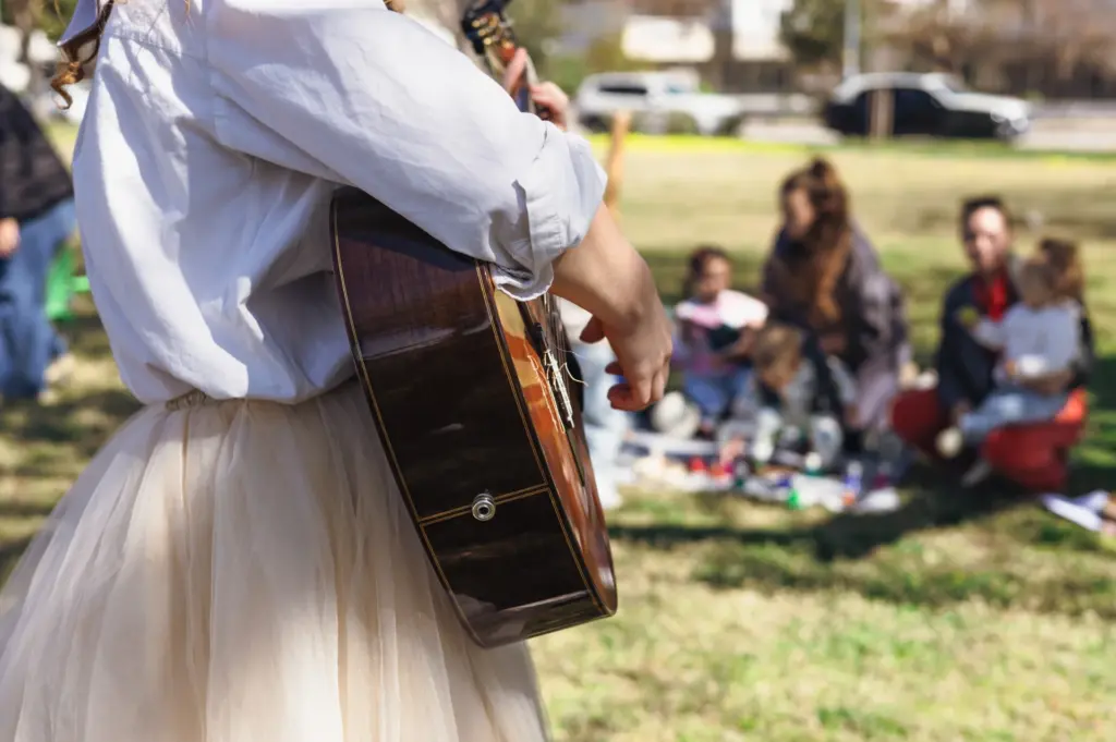 A woman plays guitar at a memorial service