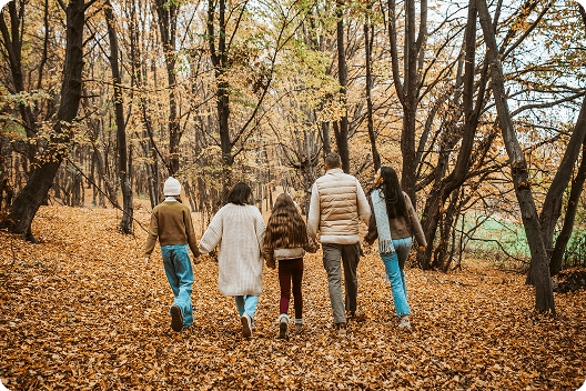Couple silhouetted against a beautiful sunrise while walking up a hill together, representing the tranquility and peace of mind achieved through advance cremation planning with Everis Complete Cremation.