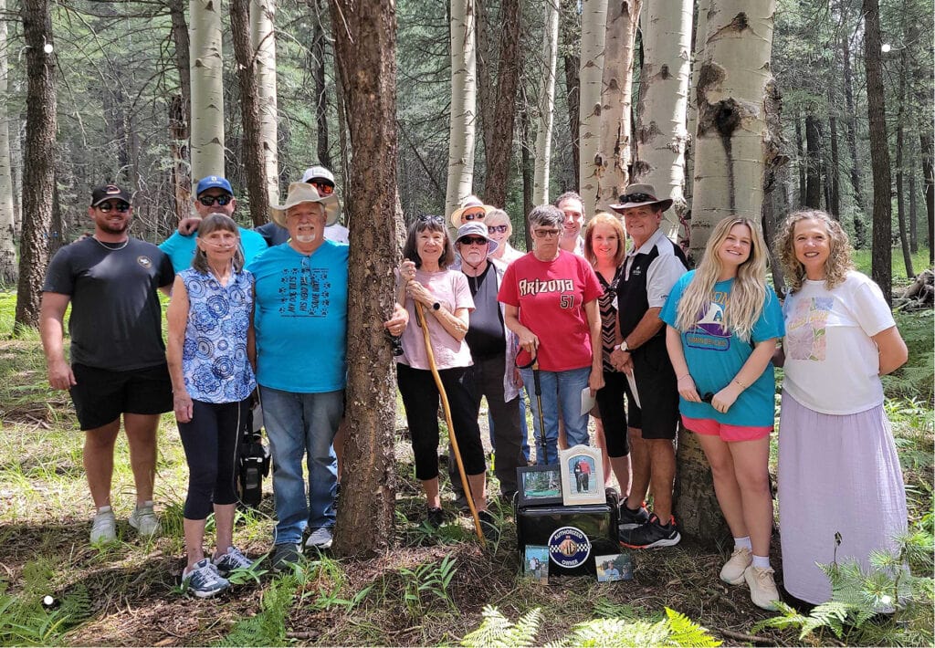 The Pottinger family gathers at Don's Memorial Tree after his Nature Memorial ceremony. His wife Ginger takes comfort knowing she and her family will join him at the tree one day.
