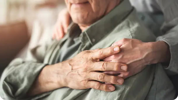 Comforting hand on shoulder supporting elderly man