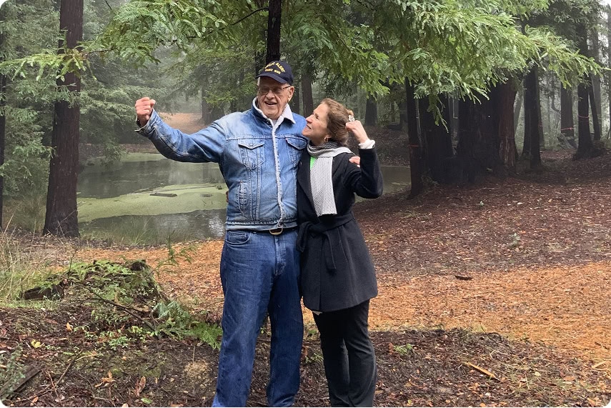 A couple embracing in the forest.
