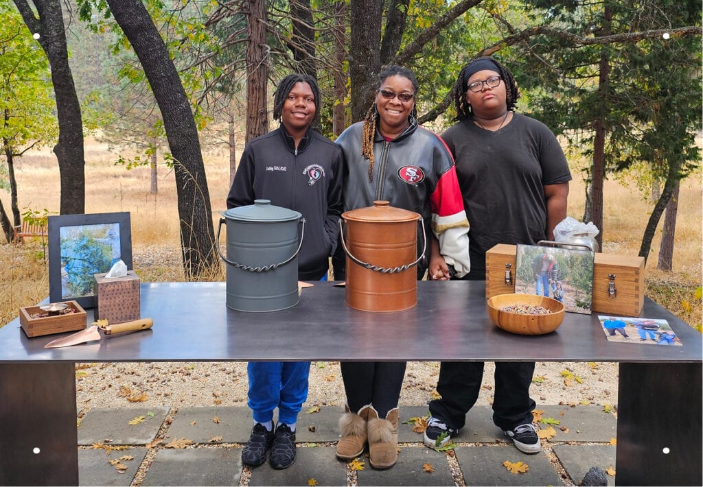 A portrait of a mother with her two sons during a Nature Memorial ceremony in the Memorial Forest.